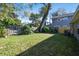 Backyard with large tree, grassy area, and fence at 116 S Hale Ave, Tampa, FL 33609