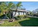 Gray house with palm trees, well-manicured lawn, and a carport at 116 S Hale Ave, Tampa, FL 33609