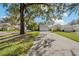 Gray house with a two-car garage and a tree-lined driveway at 1416 Walden Oaks Pl, Plant City, FL 33563