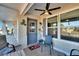 Enclosed front porch with seating and a ceiling fan, creating a welcoming entry at 1510 Arrowhead Dr, Sun City Center, FL 33573