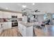 Bright kitchen features an island, white cabinets, and wood-look flooring at 1510 Arrowhead Dr, Sun City Center, FL 33573