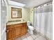 Bathroom with granite countertop, wooden vanity, and shower at 1515 Pinellas Bayway S # 40, St Petersburg, FL 33715