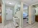 Entryway with white console table, view of bedroom and bathroom at 1515 Pinellas Bayway S # 40, St Petersburg, FL 33715