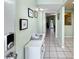 Condo entry with keyless entry, white console table, and view into living area at 1515 Pinellas Bayway S # 40, St Petersburg, FL 33715