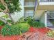 Condo building entrance with lush landscaping and red mulch at 1515 Pinellas Bayway S # 40, St Petersburg, FL 33715