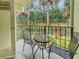 Private patio with metal table and chairs, overlooking green space at 1515 Pinellas Bayway S # 40, St Petersburg, FL 33715