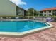 Community pool with surrounding patio furniture at 1515 Pinellas Bayway S # 40, St Petersburg, FL 33715