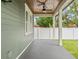 Covered patio with wood ceiling and grey concrete flooring at 1903 E New Orleans Ave, Tampa, FL 33610