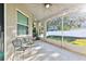 Screened porch overlooking backyard with seating at 19156 Meadow Pine Dr, Tampa, FL 33647