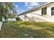 House side yard view with lush grass and privacy fence at 19156 Meadow Pine Dr, Tampa, FL 33647