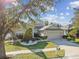 Single-story home with a two-car garage and landscaped yard at 19156 Meadow Pine Dr, Tampa, FL 33647