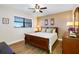 Cozy bedroom with a queen-size bed and hardwood floors at 19451 Gulf Blvd # 806, Indian Shores, FL 33785