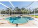 Inviting kidney-shaped pool with a spa and screened enclosure at 19829 Morden Blush Dr, Lutz, FL 33558