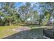 Spacious backyard with grassy area and mature trees at 2014 E Genesee St, Tampa, FL 33610