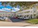 Condo building with ample parking and lush landscaping at 2451 Canadian Way # 47, Clearwater, FL 33763