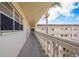 Outdoor hallway with white railings and building access at 2451 Canadian Way # 47, Clearwater, FL 33763