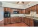 Well-equipped kitchen with wood cabinets and granite countertops at 2451 Canadian Way # 47, Clearwater, FL 33763