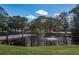 Serene pond with a wooden footbridge and fountain at 2451 Canadian Way # 47, Clearwater, FL 33763
