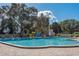 Community pool with lounge chairs and brick patio at 2451 Canadian Way # 47, Clearwater, FL 33763