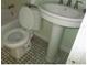 Small bathroom with pedestal sink, toilet, and bathtub at 27 80Th Ave, Treasure Island, FL 33706