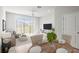 Bright dining area with wood table and chairs, adjacent to living room at 31386 Amberview Bnd, Wesley Chapel, FL 33545