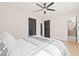 Bedroom with queen bed, light flooring, ceiling fan, and access to bathroom at 316 W Fern St, Tampa, FL 33604