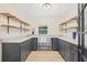 Butler's pantry with dark cabinetry, stainless steel sink, and open shelving at 316 W Fern St, Tampa, FL 33604