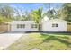 Newly renovated single-story home with white brick exterior and landscaped yard at 316 W Fern St, Tampa, FL 33604