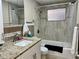 Bathroom with tiled shower, granite vanity top, and white cabinetry at 3649 Bradford Dr, Holiday, FL 34691