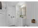 Simple bathroom with white vanity, toilet and wood-paneled walls at 4015 Bayshore Blvd # 16A, Tampa, FL 33611