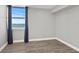 Bright bedroom with water views, hardwood floors, and navy blue curtains at 4015 Bayshore Blvd # 16A, Tampa, FL 33611