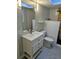 Bathroom with light gray walls, white vanity and subway tile shower with a glass panel at 4500 37Th S St # 27, St Petersburg, FL 33711