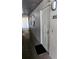 View of unit 305's entrance with secure white metal door and black door mat at 4500 37Th S St # 27, St Petersburg, FL 33711