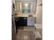 Small condo kitchen with white cabinets and appliances at 4500 37Th S St # 27, St Petersburg, FL 33711