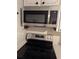 New stainless steel microwave and electric range with black stovetop and silver knobs at 4500 37Th S St # 27, St Petersburg, FL 33711