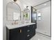 Elegant bathroom with double vanity, quartz countertop, and black cabinetry at 475 Island Way, Clearwater Beach, FL 33767