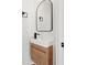 Modern bathroom with floating vanity and arched mirror at 475 Island Way, Clearwater Beach, FL 33767