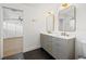 Double vanity bathroom with grey cabinets and gold fixtures at 475 Island Way, Clearwater Beach, FL 33767