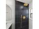 Stylish bathroom featuring a frameless glass shower with geometric tile at 475 Island Way, Clearwater Beach, FL 33767