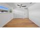 Bright bedroom with hardwood floors, ceiling fan, and white walls at 475 Island Way, Clearwater Beach, FL 33767