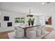 Modern dining room features a wood table, white chairs, and pool view at 475 Island Way, Clearwater Beach, FL 33767