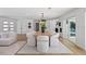Open concept dining area with light wood floors and modern furniture at 475 Island Way, Clearwater Beach, FL 33767