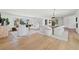 Modern dining room with light oak floors and stylish light fixture at 475 Island Way, Clearwater Beach, FL 33767