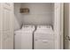 Laundry room with a white washer and dryer, and wire shelving at 4781 Vignette Way, Sarasota, FL 34240