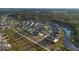 Aerial view of a residential neighborhood with houses and a lake at 6670 Paden Wheel St, Zephyrhills, FL 33541