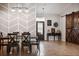 Spacious dining area with chevron accent wall and farmhouse style table at 6670 Paden Wheel St, Zephyrhills, FL 33541