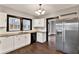 Modern kitchen with white cabinets and granite countertops at 671 Jasmine S Way, St Petersburg, FL 33705