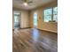 Bright living room with wood-look floors and access to other rooms at 7101 Carlow St, New Port Richey, FL 34653