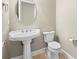 Clean powder room with pedestal sink and a toilet at 7416 S Morton St, Tampa, FL 33616