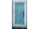 Light teal front door with black hardware and marble threshold at 812 Franklin Cir, Palm Harbor, FL 34683